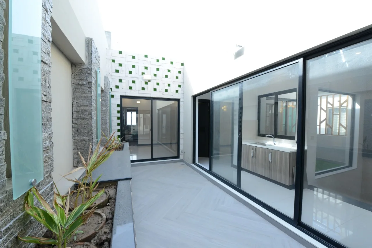 A modern glass-fronted house listed by Azam Real Estate