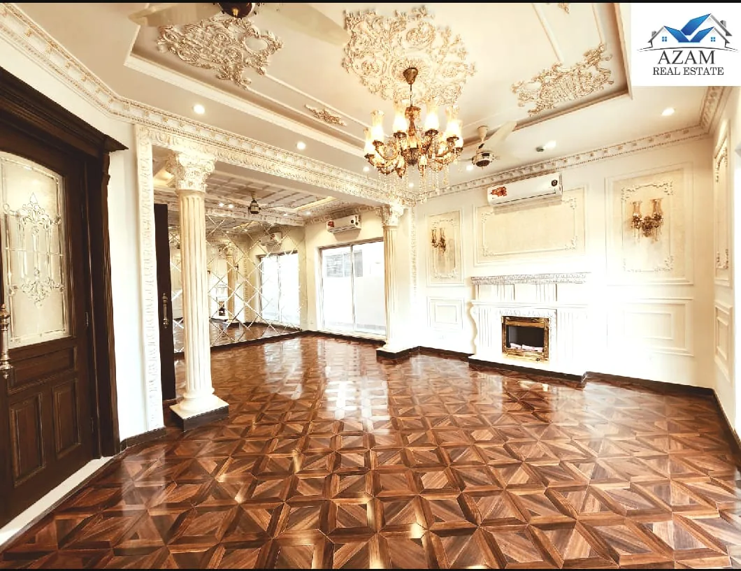 A double-height hall with a chandelier in a listed house